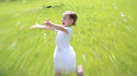 Toddler plays with soap bubbles in the park. Stock Footage 38352272