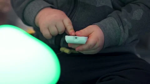 Toddler Pressing Button on Small White Remote: Close-Up Stock Footage 325131246