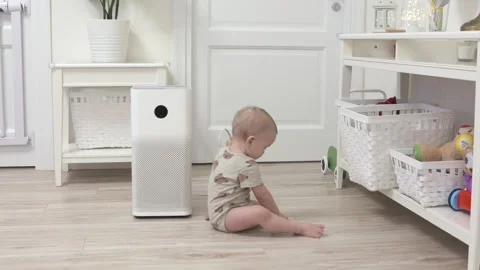 Toddler pulls the electric plug out of socket, 1 year old infant playing with Stock Footage 172368544