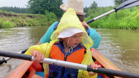 Toddler is rowing the kayak by the scull Stock Footage 279503500
