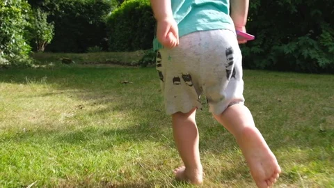 Toddler running on grass in pyjarmas. Stock Footage 111627995