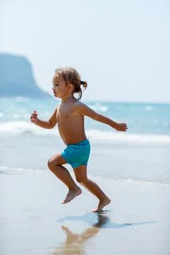 Toddler Running On Sandy Beach Stock Photos