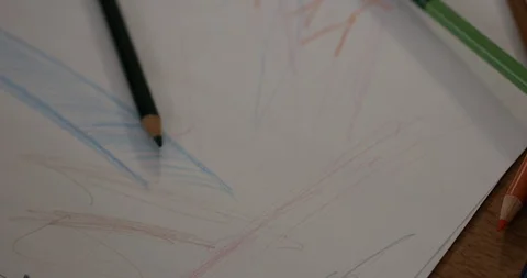 Toddler scribbling with colored pencils on paper Stock Footage 88961472