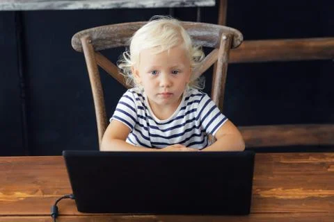 Toddler sits in front of a laptop Foto stock