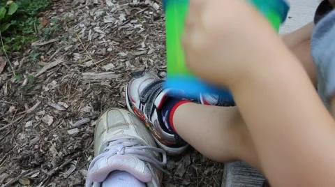 Toddler sits on front porch while eating a snack Stock Footage 44445861