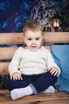 Toddler sitting on the bench Stock Photos