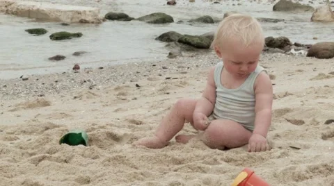 Toddler sitting in the sand at the beach.mov Stock Footage 59100709