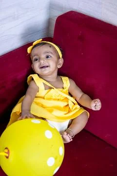 Toddler sitting at sofa cute expression at indoor from different angle Foto stock