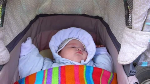 Toddler sleeping in a stroller Stock Footage 130488566