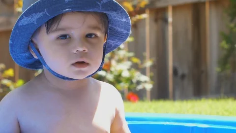 Toddler in Small Pool Looking at Camera Stock Footage 90224453