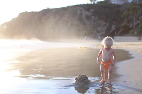 Toddler standing on beach Stock Photos