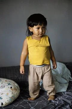 Toddler Standing On Bed 写真素材