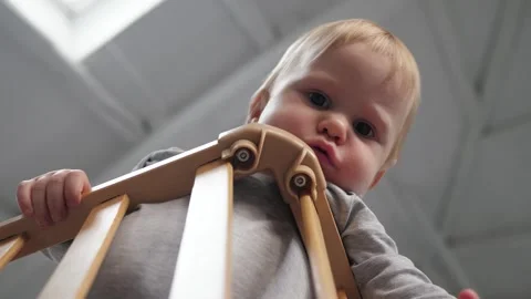 Toddler is standing in the crib Stock Footage 312529726