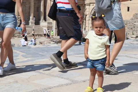 Toddler standing pose between the crowded tourists in the Ephesus Stock Photos