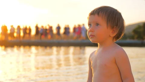 Toddler standing on the seashore during sunset. Mental health. Children Stock Footage 120772837