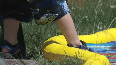Toddler  stepping into a wading pool. Stock Footage 29979383