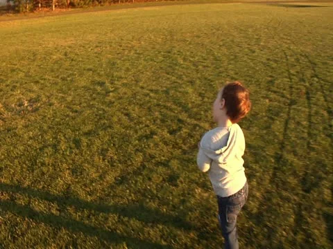 Toddler stumbling with ball Stockbeeldmateriaal 20495938