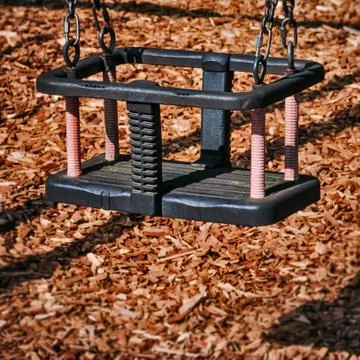 Toddler swing empty in the playground square composition Foto stock