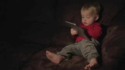 Toddler with tablet computer on the couch Stock Footage 59122676