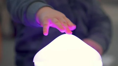 Toddler Taking Off And Putting Back Glowing Cover Of Night Lamp In Bedroom Stock Footage 330192817