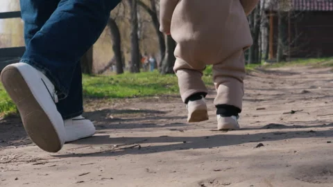 Toddler Taking First Steps on Dirt Path in Warm Cinematic Sunlight Stock Footage 333816419