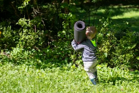 Toddler Toting a Load Foto stock