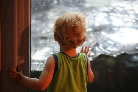 Toddler touching glass Stock Photos