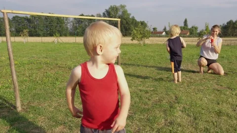 Toddler Turn Chase Bubbles - 4k - Slow motion Stock Footage 70447999