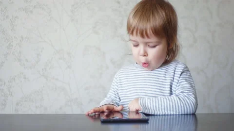 Toddler using digital tablet. Baby child looking at the screen of the digital Stock Footage 151695266
