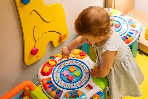 Toddler using an interactive toy for learning shapes. Concept of fun and Stock Photos