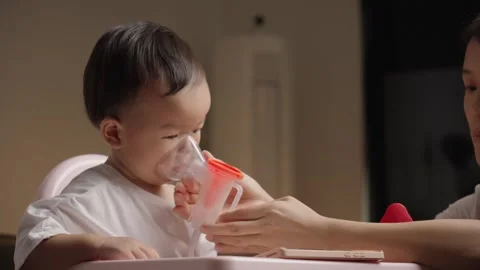 Toddler Using Nebulizer Mask for Inhalation Therapy at Home Видео 339079268