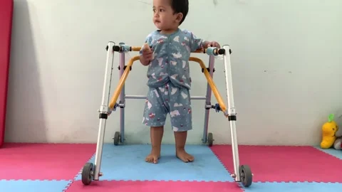 Toddler Using a Pediatric Mobility Walker Stock Footage 341914372
