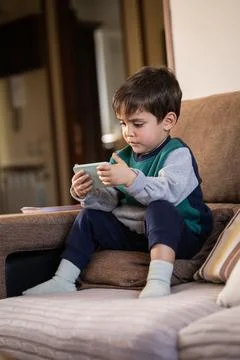 Toddler Using a Smartphone, Engaged in Digital Entertainment Stock Photos
