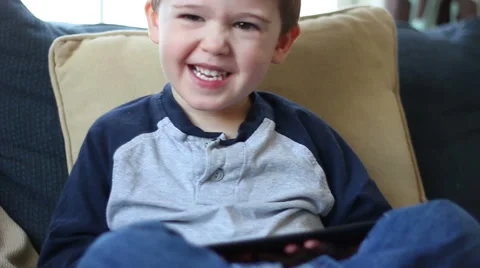 Toddler using tablet computer and smiles Stock Footage 44577848