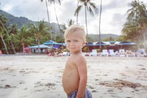 Toddler walking on a beach 写真素材