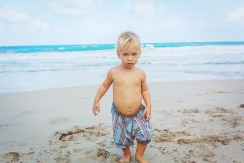 Toddler walking on a beach Stock Photos