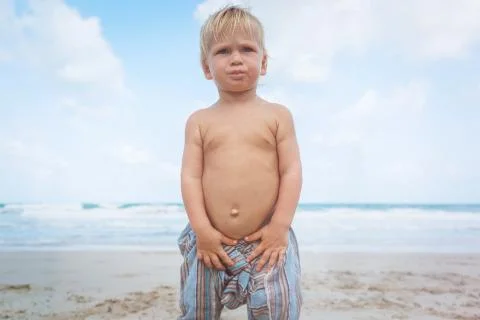 Toddler walking on a beach Stock Photos