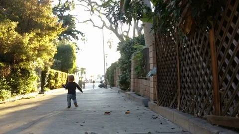 Toddler Walking Down Sidewalk Stock Footage 75774049