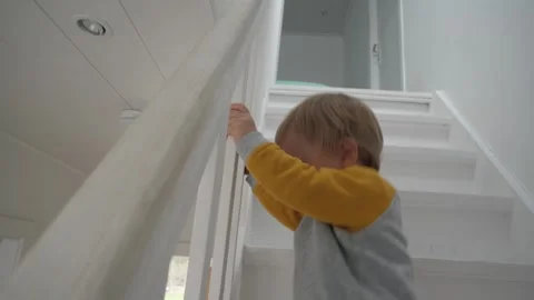 Toddler walks down stairs Stock Footage 303498135