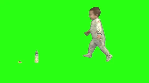 Toddler walks onscreen from right and sits next to his bottle. Green background. Video stock 49864491