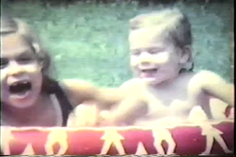 Toddler waves to camera, plays in pool with sister, late 60's Video stock 36094267