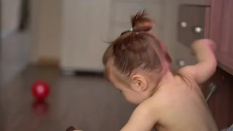 Toddler without clothes eats ice cream in chocolate and watches tv Stock Footage 153132953