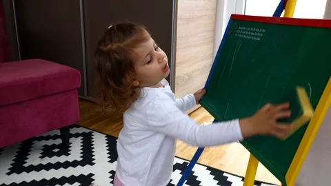 Toddler writing on board, home study Stockbeeldmateriaal 128951069