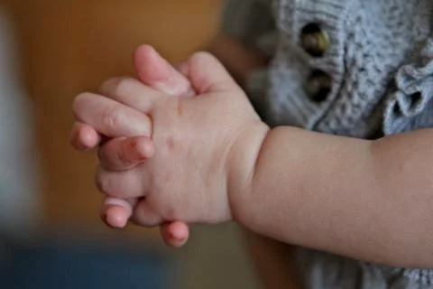 Toddler's clasped hands Stock Photos
