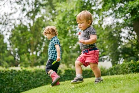 Toddlers exploring park Stock Photos