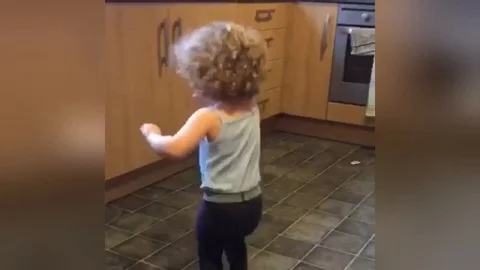 Toddlers funky dance to Bruno Mars sends her falling out of room Stock Footage 109252466