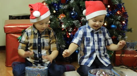Toddlers playing with candy box covers on Christma Stock Footage 57647532