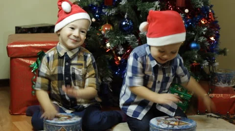 Toddlers playing drums with candy boxes on Christmas Stock Footage 57646941