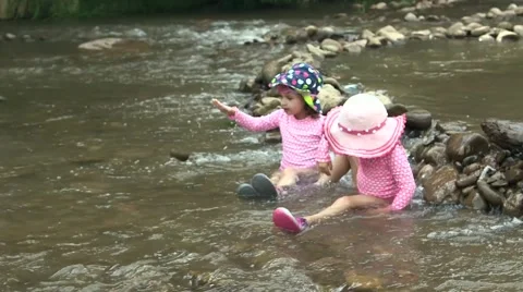 Toddlers playing in riverbed 01 Stock Footage 43386546