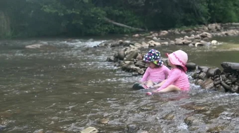 Toddlers playing in riverbed 02 Stock Footage 43386588